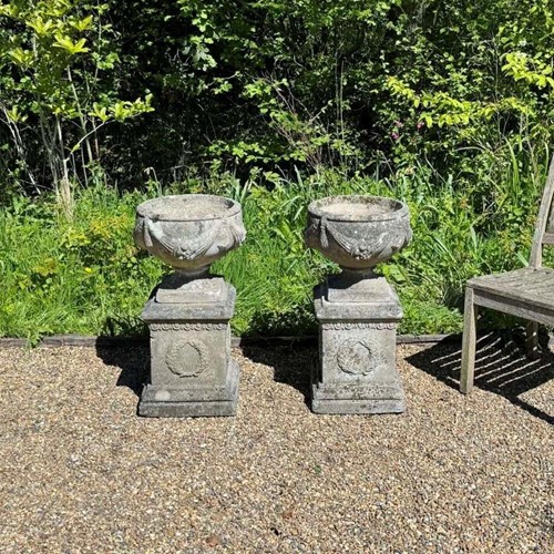 Pair of Patinated Goblet Urns and Pedestals