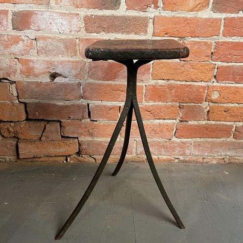 A Three Legged Industrial Stool