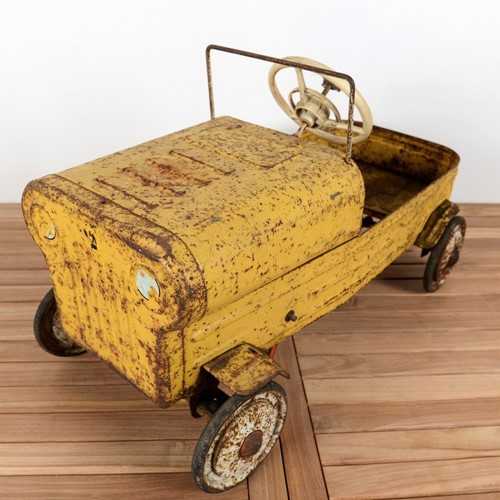 Old yellow military style metal pedal car