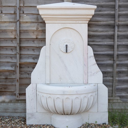 Hand-carved stone wall fountain
