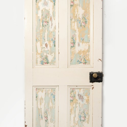 Old door with pretty wallpaper