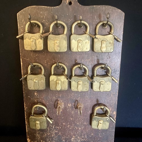 Brass Pad Locks On Wooden Shop Board