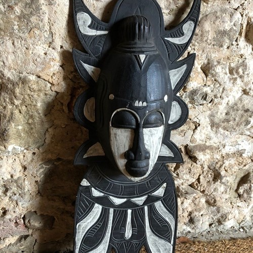 A Black and White Carved Mask 